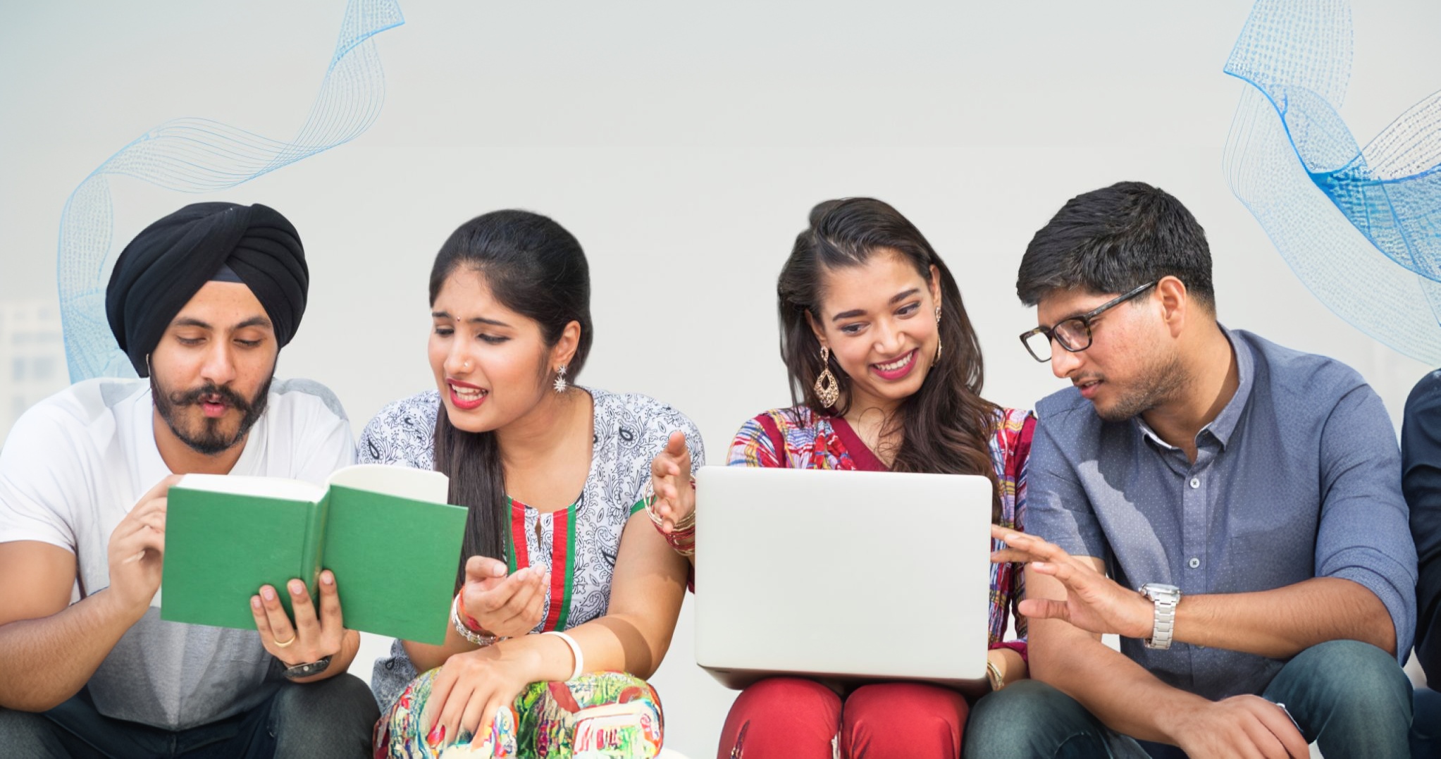 A group of young people sitting on a couch, focused on their laptops, discussing degree courses after intermediate.
